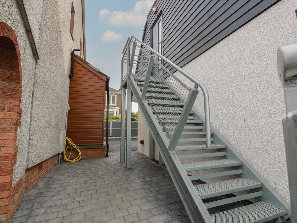An outdoor area with a staircase next to walls and a door at Lazy Bulldog
