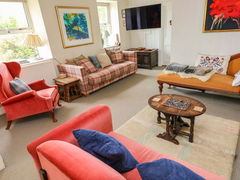 A living room with sofas and a coffee table at The Pink House Nine Wells near Solva