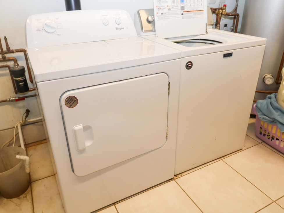 A washing machine and dryer in a laundry room at Hayloft Ipswich