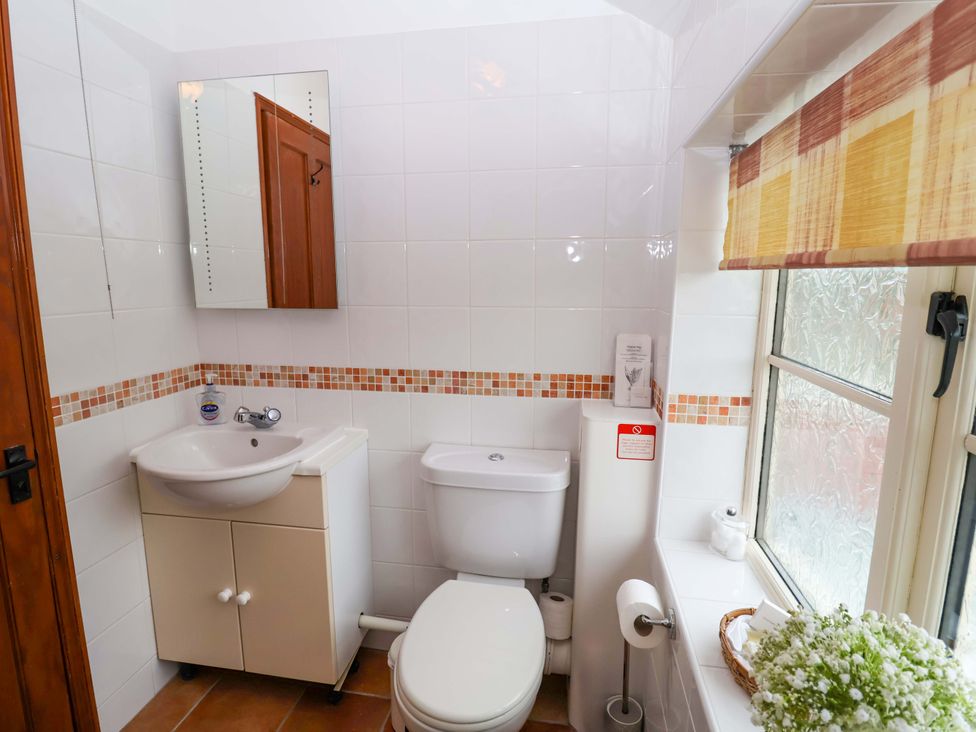 A bathroom with a sink and toilet at Hayloft in Ipswich
