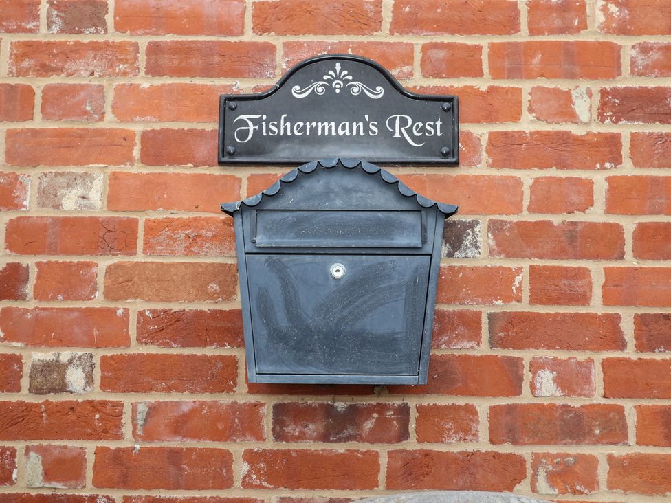 A mailbox and nameplate on a brick wall at Fisherman's Rest in Ipswich