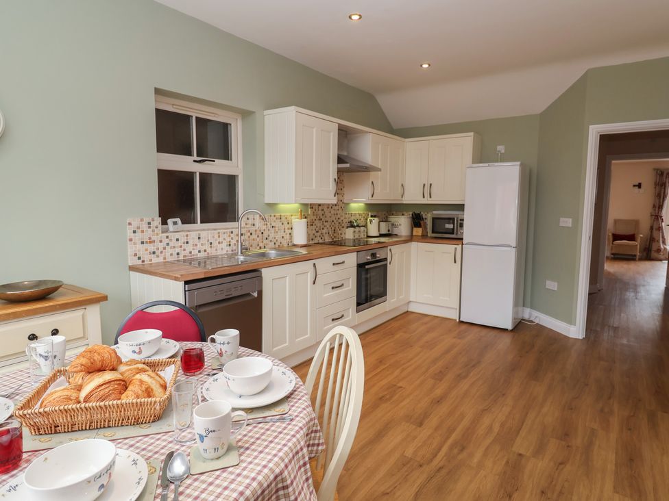 A kitchen with a dining table and appliances at Fisherman's Rest Ipswich