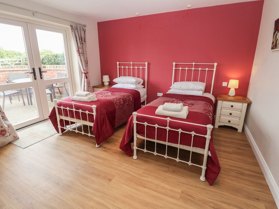A bedroom with two single beds and a bedside table at Fisherman's Rest in Ipswich