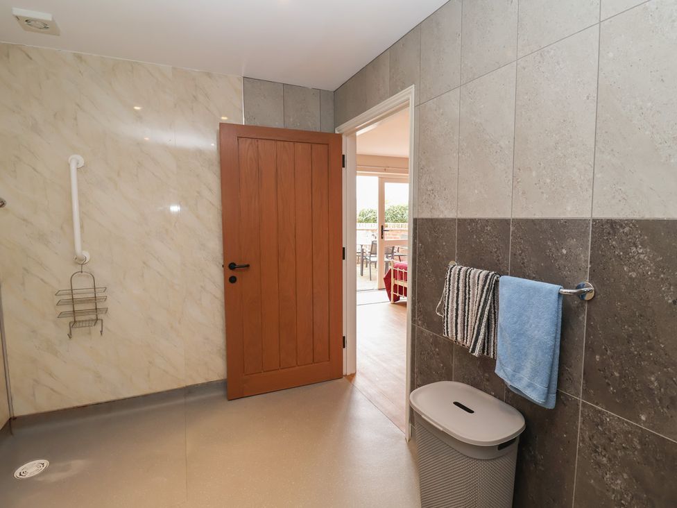A bathroom with a shower and towels hanging at Fisherman's Rest Ipswich