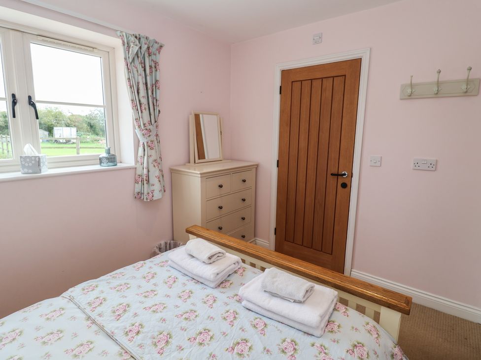 A bedroom with a bed and a dresser at Fisherman's Rest in Ipswich