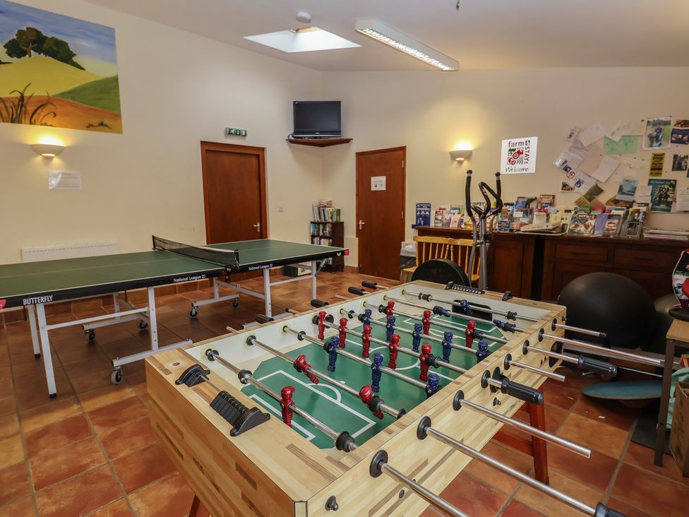 A recreation room with ping pong and foosball tables at Fisherman's Rest in Ipswich