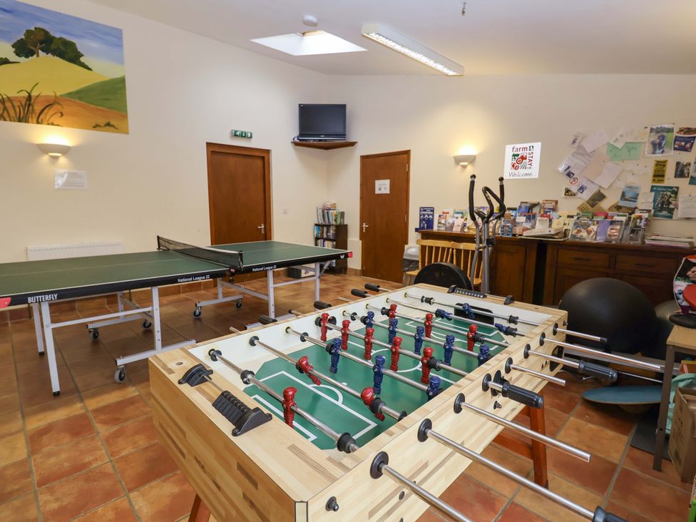 A games room with table tennis and foosball tables at Coachman's Cottage in Ipswich