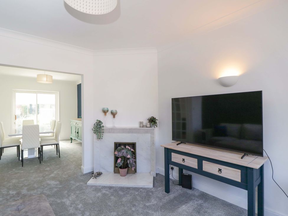 A living room with a television and fireplace at 6 Newbridge Gardens Bath