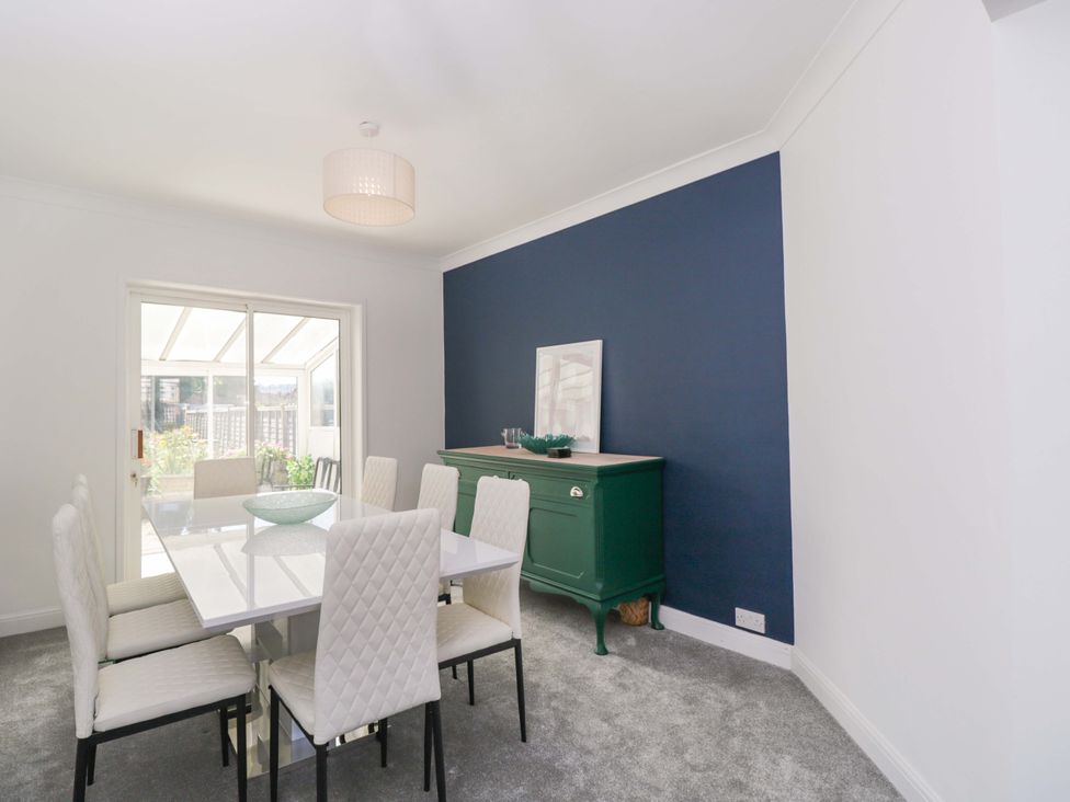 A dining room with a table and chairs at 6 Newbridge Gardens Bath
