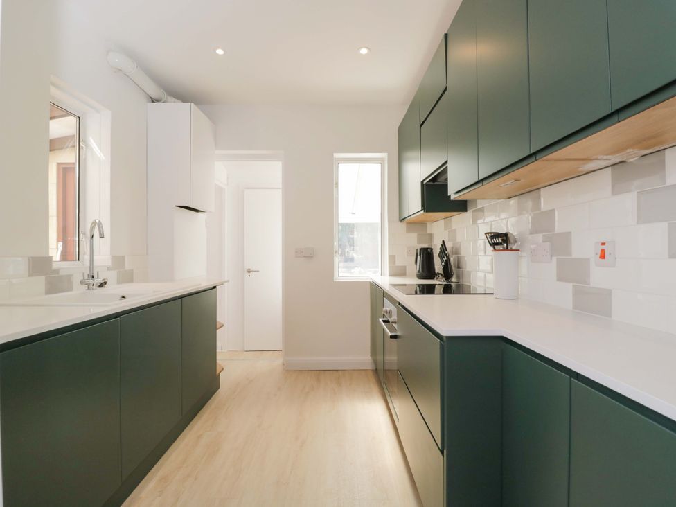 A kitchen with cabinets and a sink at 6 Newbridge Gardens Bath