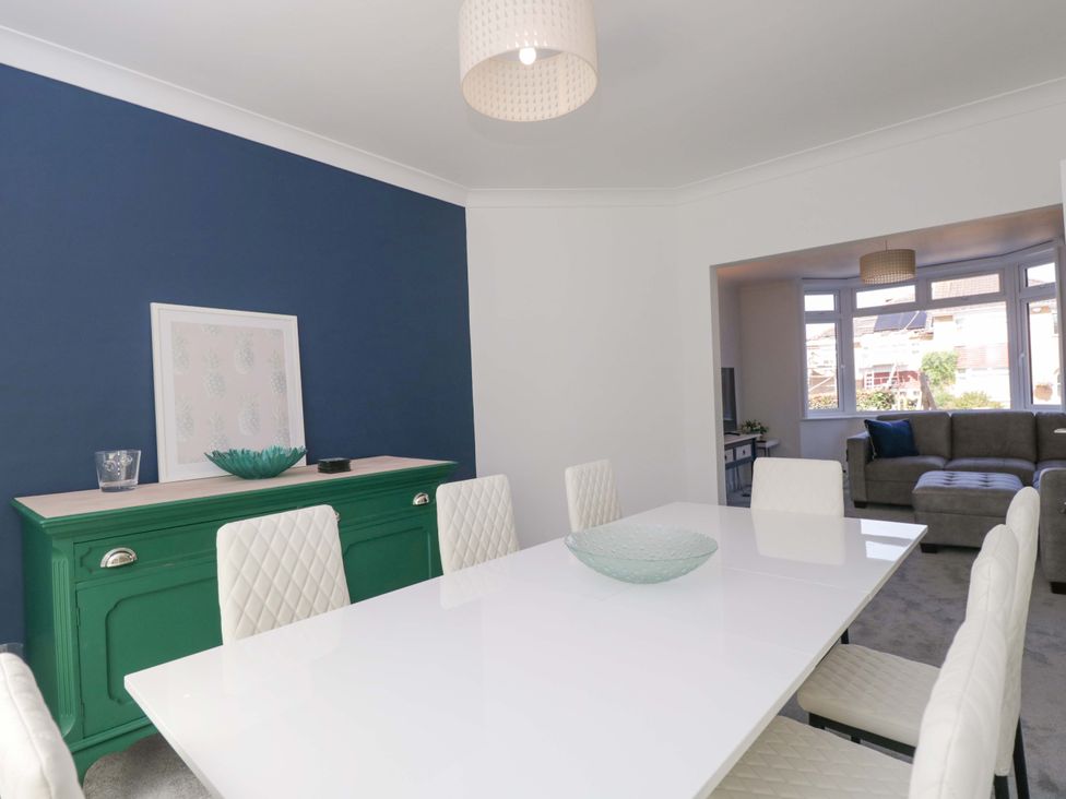 A dining room with a table and chairs at 6 Newbridge Gardens in Bath