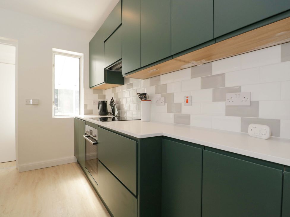 A kitchen with cabinets and appliances at 6 Newbridge Gardens, Bath