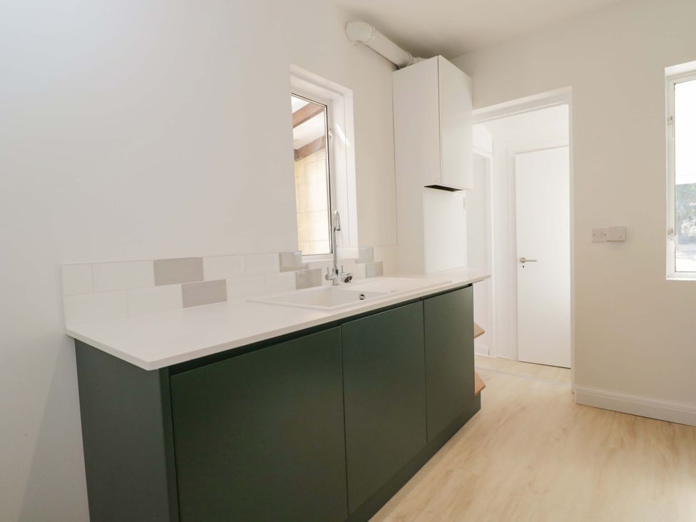 A kitchen with a sink and cabinets at 6 Newbridge Gardens Bath
