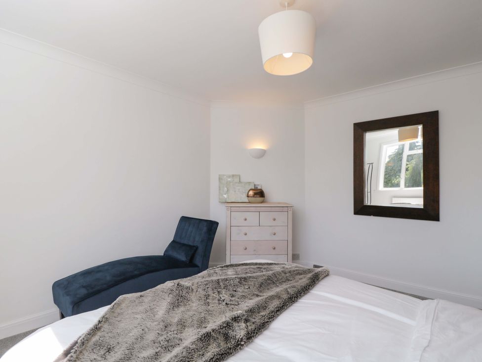 A bedroom with a bed and dresser at 6 Newbridge Gardens Bath