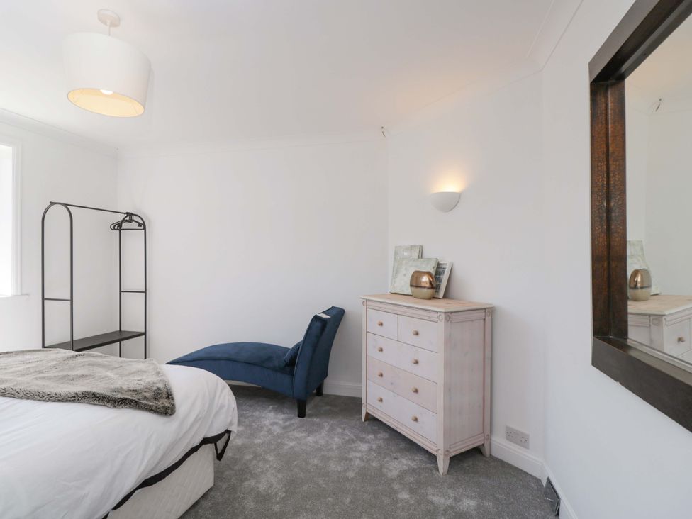 A bedroom with a bed and a wardrobe at 6 Newbridge Gardens Bath