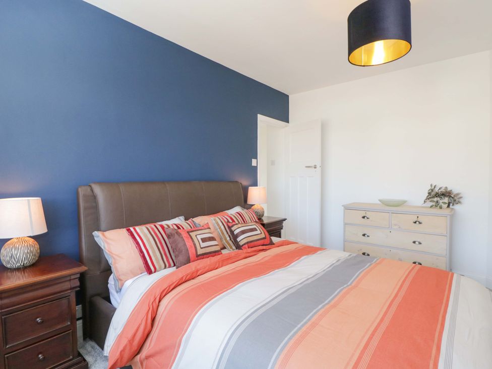 A bedroom with a bed and dresser at 6 Newbridge Gardens in Bath