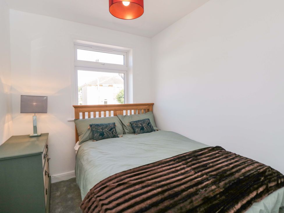 A bedroom with a bed, lamp, and drawer unit at 6 Newbridge Gardens, Bath