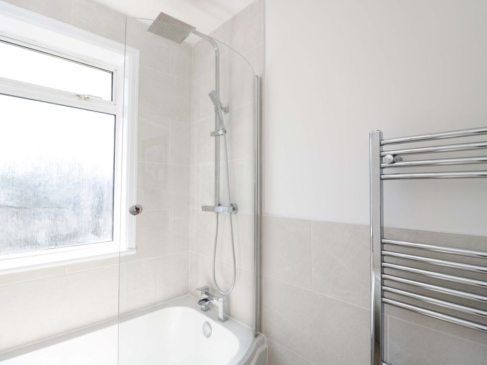 A bathroom featuring a shower and bathtub at 6 Newbridge Gardens, Bath