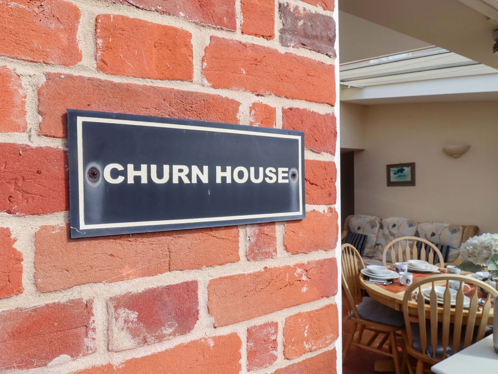 A house sign on a brick wall at Churn House in Ipswich