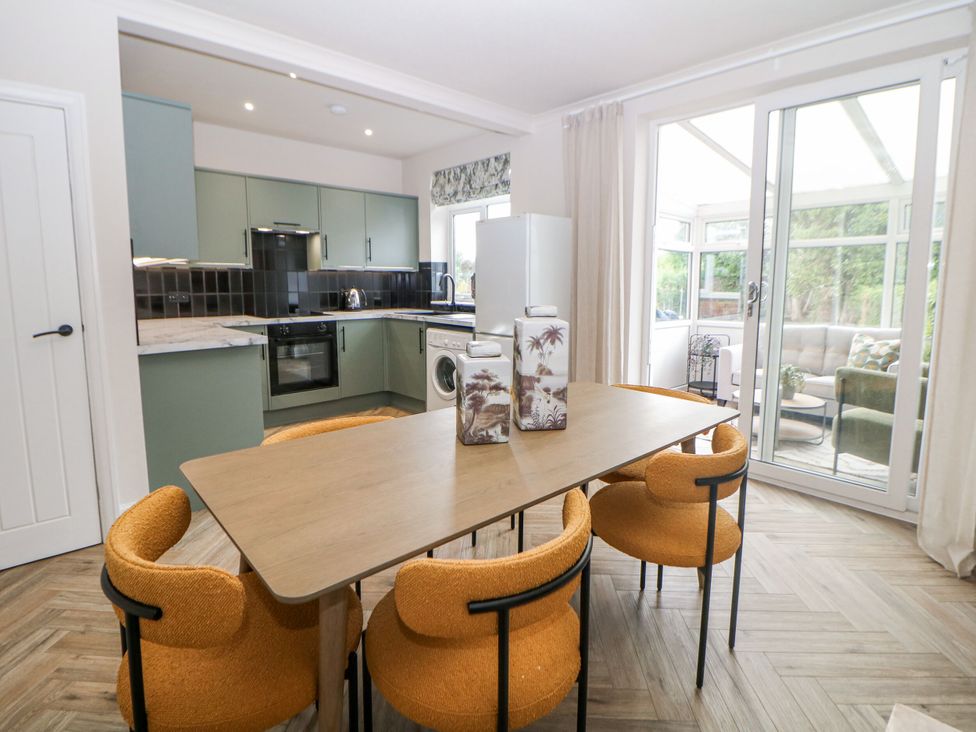 A kitchen with dining table and chairs at 37 Berry Hill Lane in Mansfield