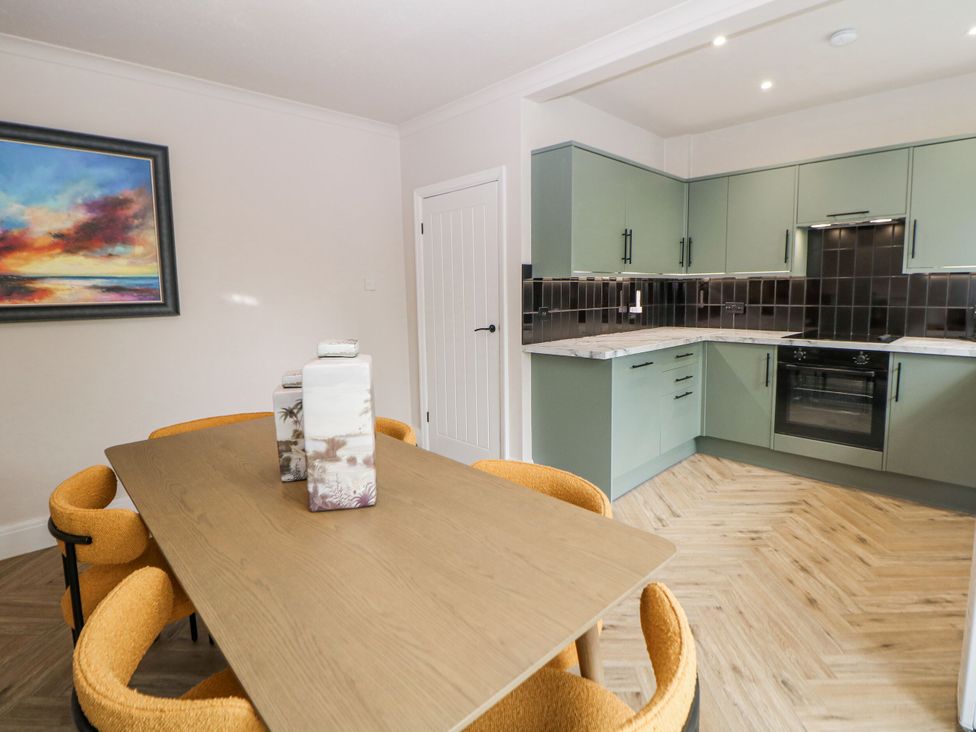 A kitchen with a dining area featuring a table and chairs at 37 Berry Hill Lane in Mansfield