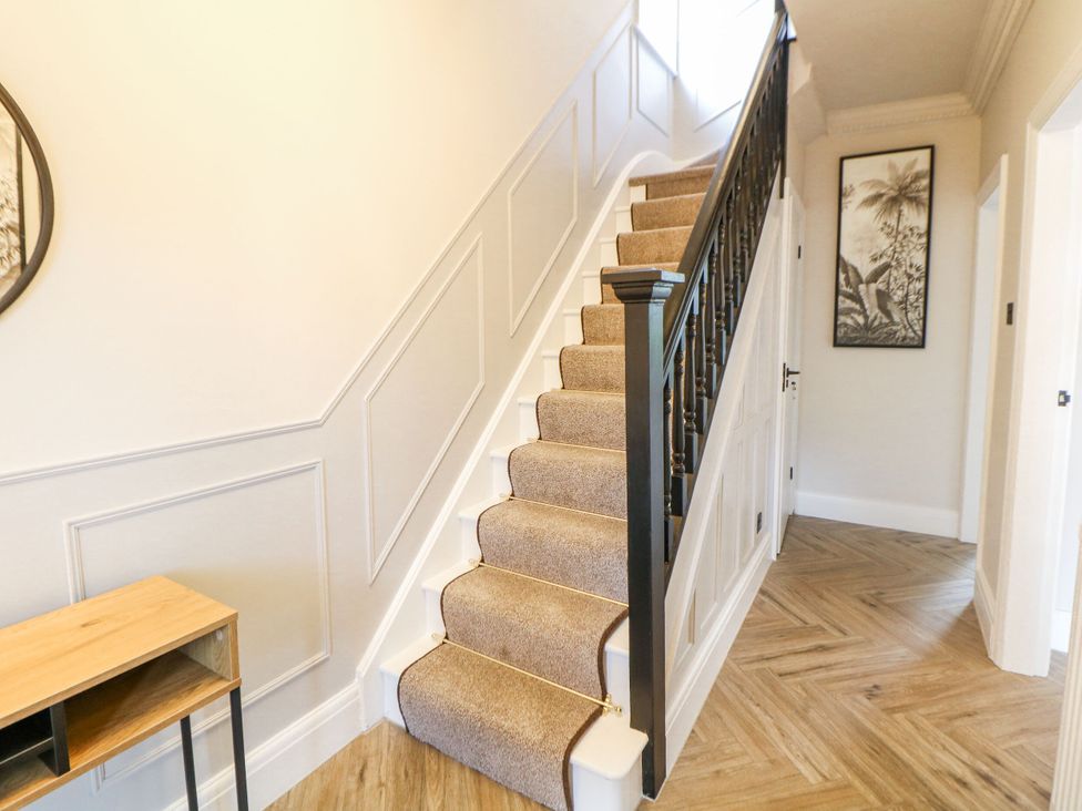 A staircase with handrail and table in a hallway at 37 Berry Hill Lane Mansfield