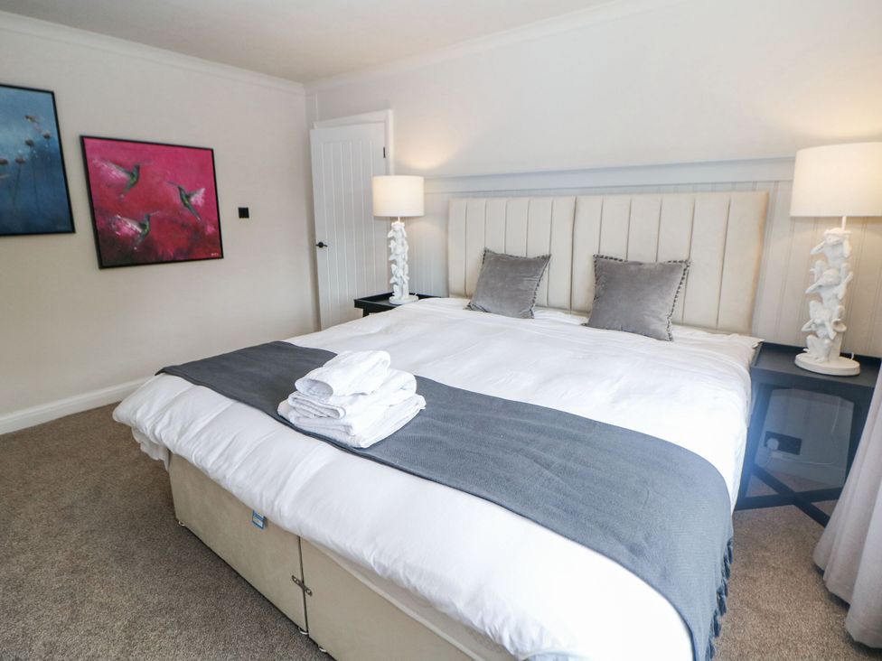 A bedroom with a bed and artwork at 37 Berry Hill Lane in Mansfield