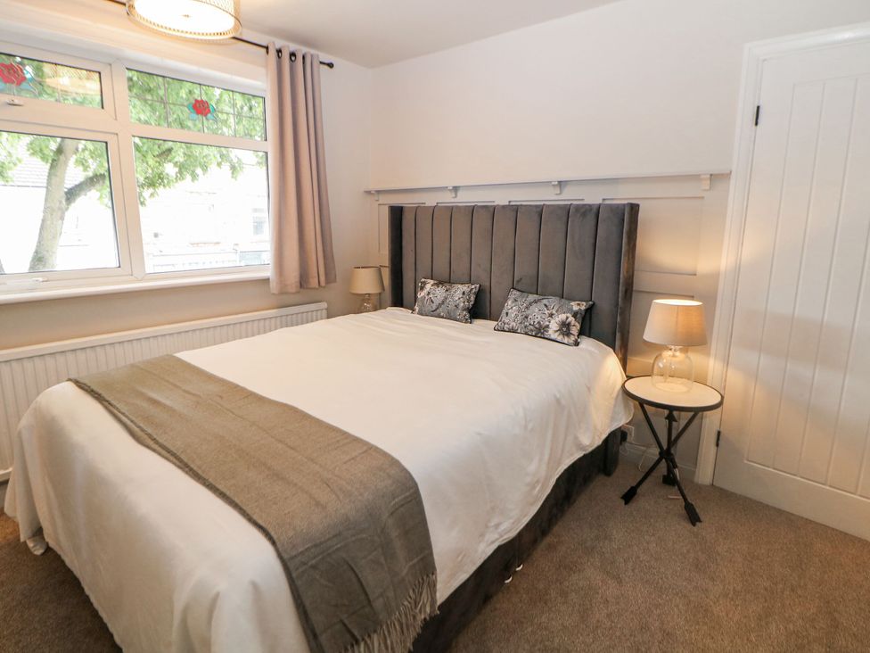 A bedroom with a bed and bedside table at 37 Berry Hill Lane in Mansfield