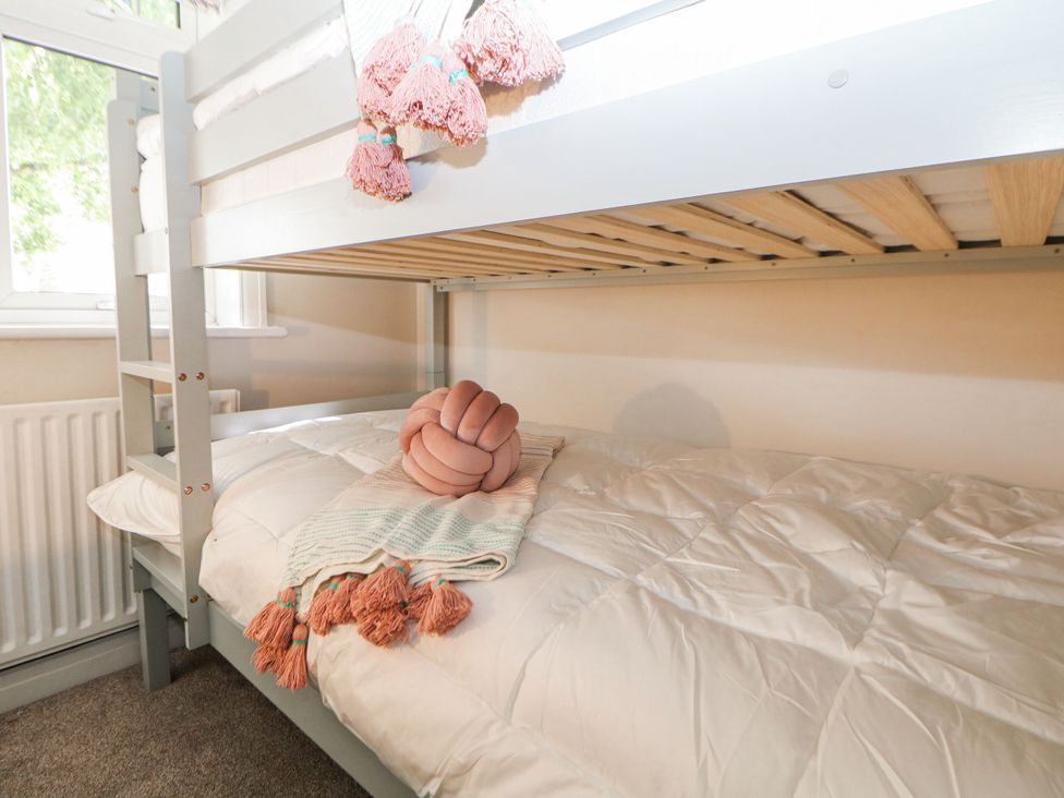 A bunk bed with a blanket and decorative pillow at 37 Berry Hill Lane in Mansfield