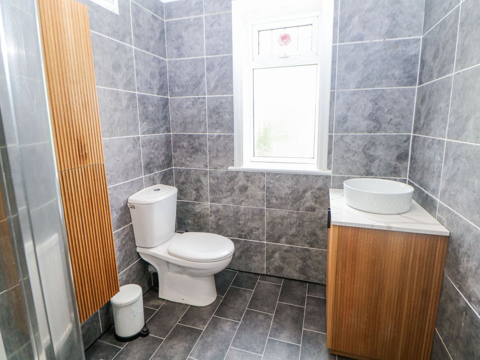 A bathroom with a toilet and sink at 37 Berry Hill Lane in Mansfield