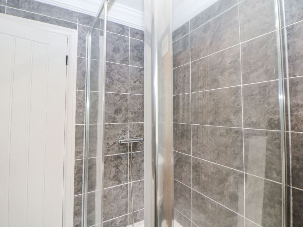 A shower area with tiles and a door at 37 Berry Hill Lane, Mansfield