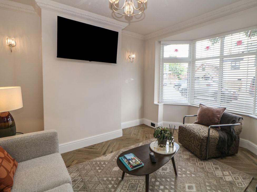 A living room with a sofa and a table at 37 Berry Hill Lane in Mansfield