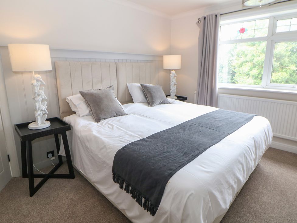 A bedroom with a bed and bedside tables at 37 Berry Hill Lane Mansfield