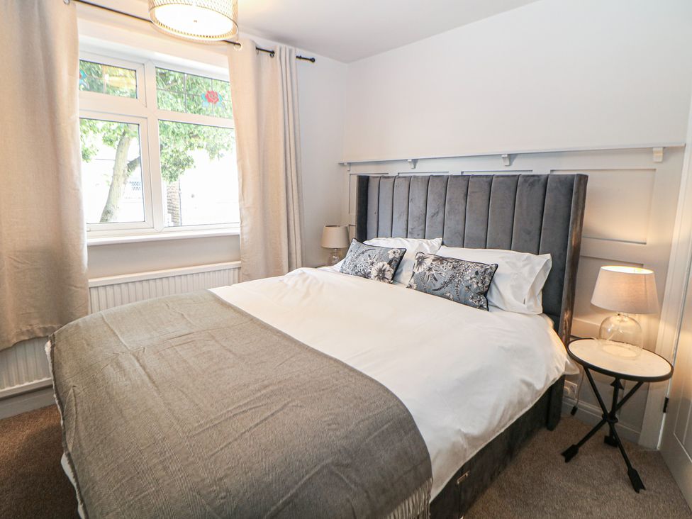 A bedroom with a bed and bedside table at 37 Berry Hill Lane Mansfield
