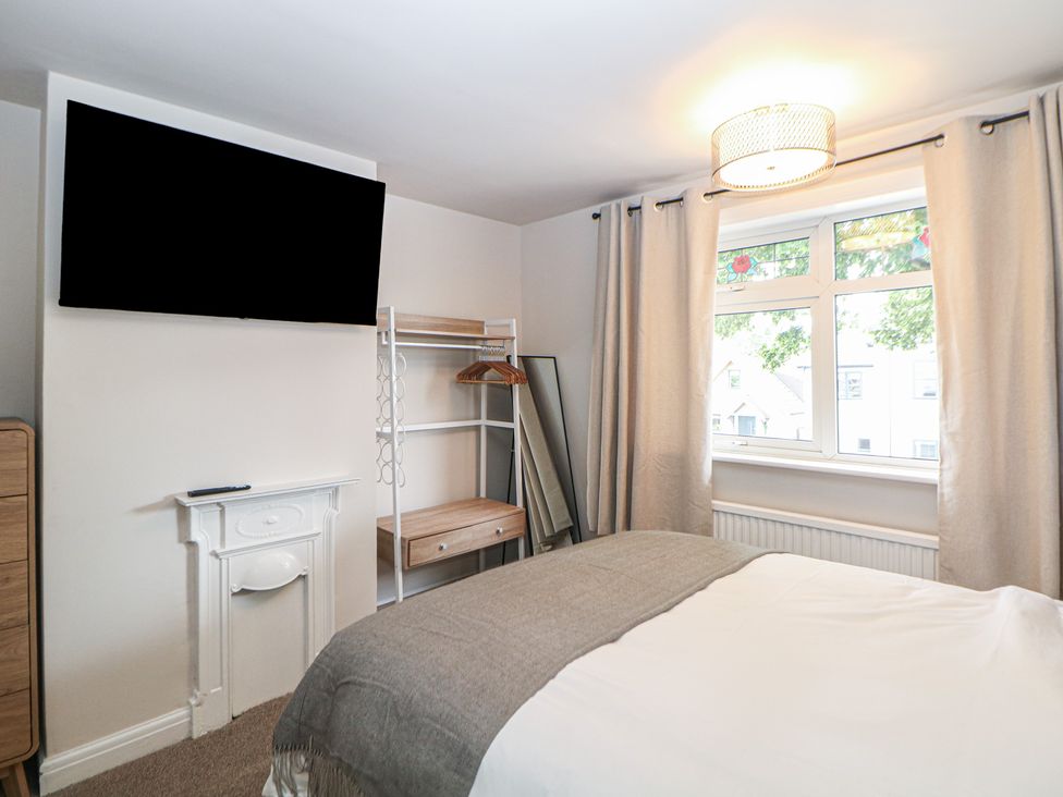 A bedroom with a television and bed at 37 Berry Hill Lane in Mansfield