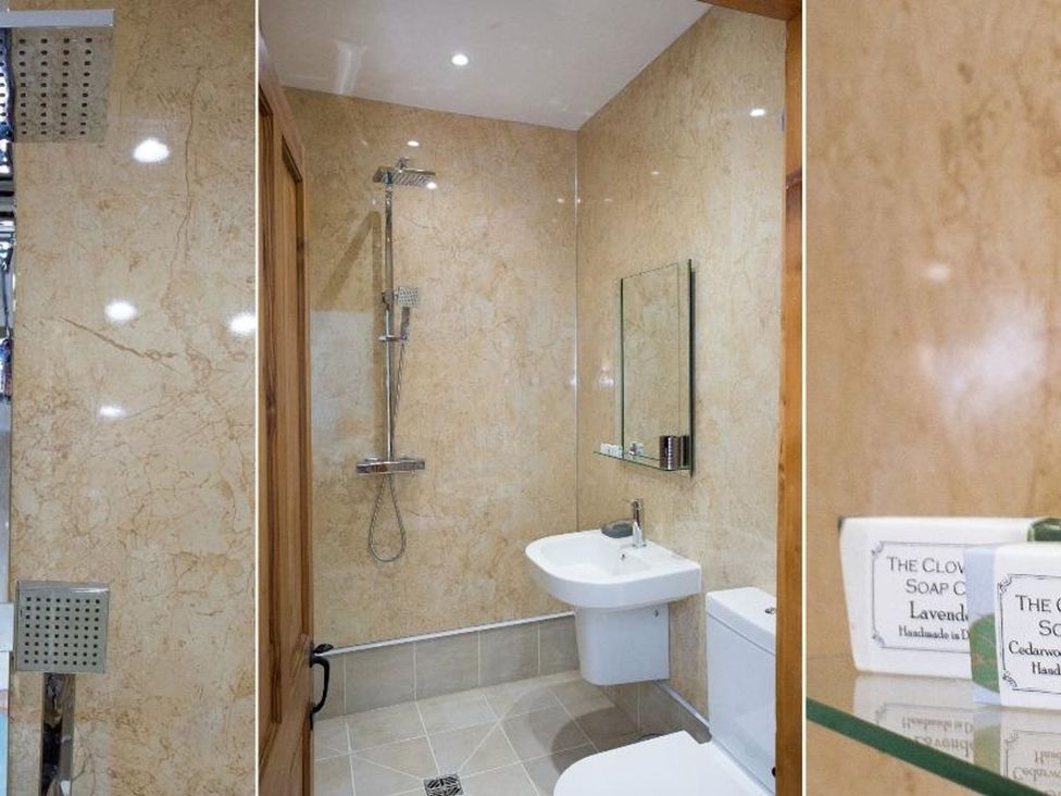 A bathroom with a shower, sink and toilet at Billy's Barn in Bradworthy