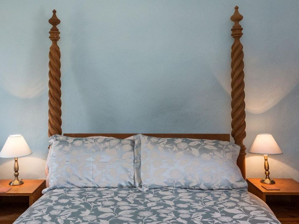 A bed with pillows and nightstands at Billy's Barn in Bradworthy
