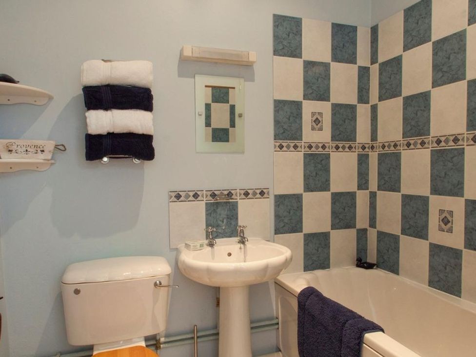 A bathroom with a sink, toilet, and bathtub at Billy's Barn in Bradworthy