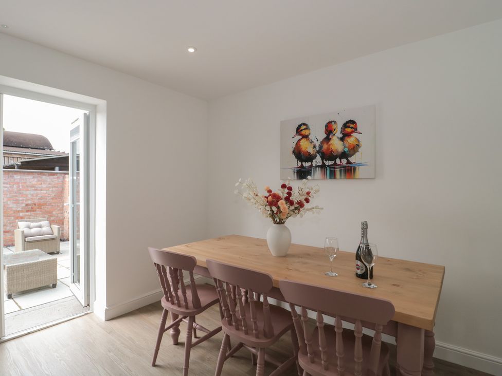 A dining room with a table and chairs at 3 The Stables Highbridge