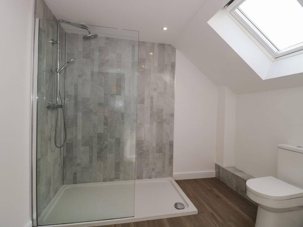 A bathroom with a shower and toilet at 3 The Stables in Highbridge