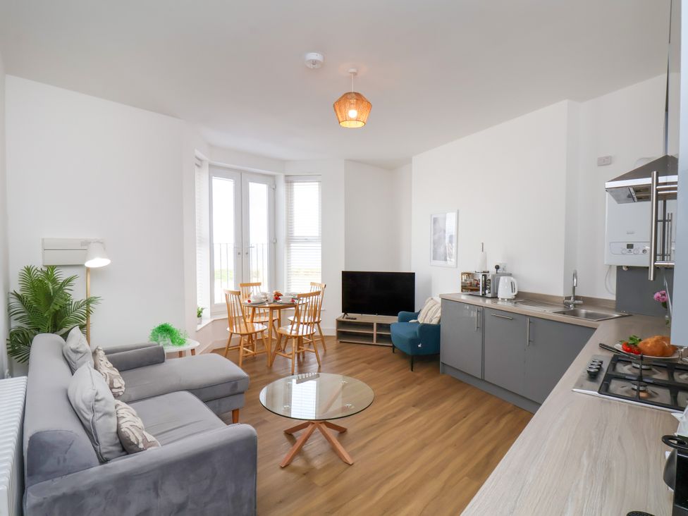 A living room with a dining area and kitchen at Apartment 3 (2 bed) Redcar