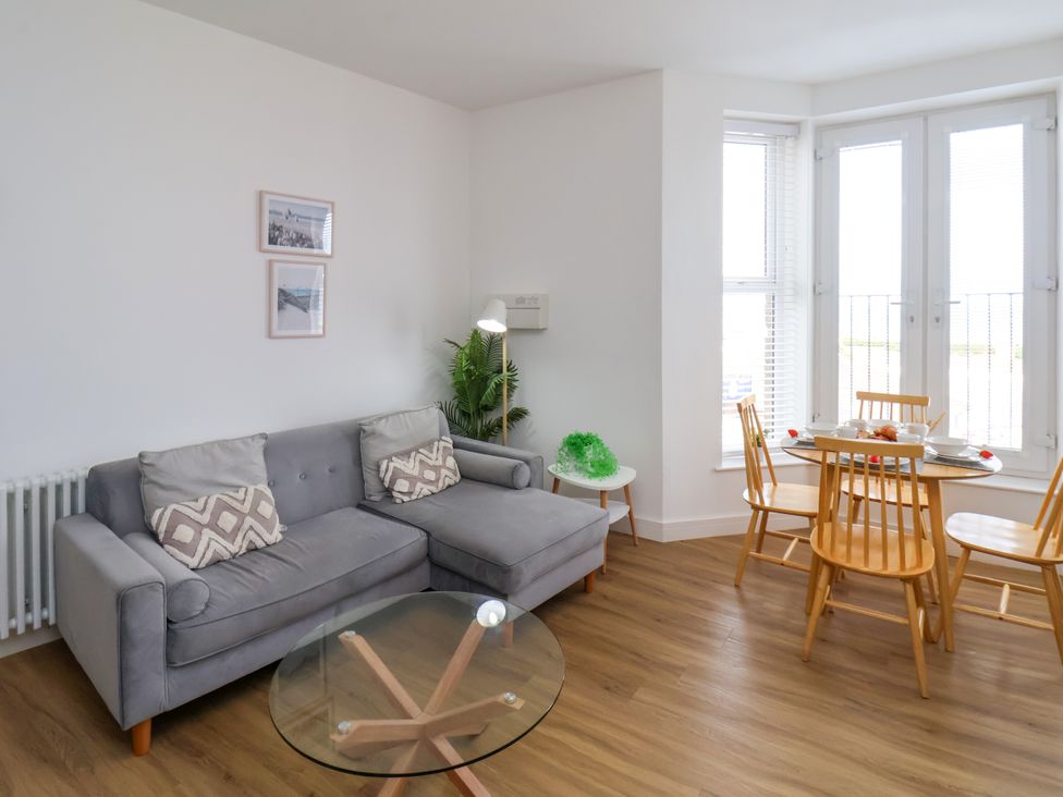 A living room with a sofa and dining set at Apartment 3 (2 bed) in Redcar