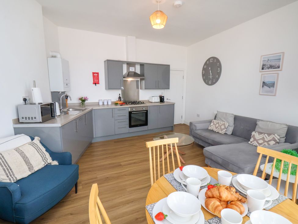 A kitchen with dining area and living space at Apartment 3 (2 bed) Redcar