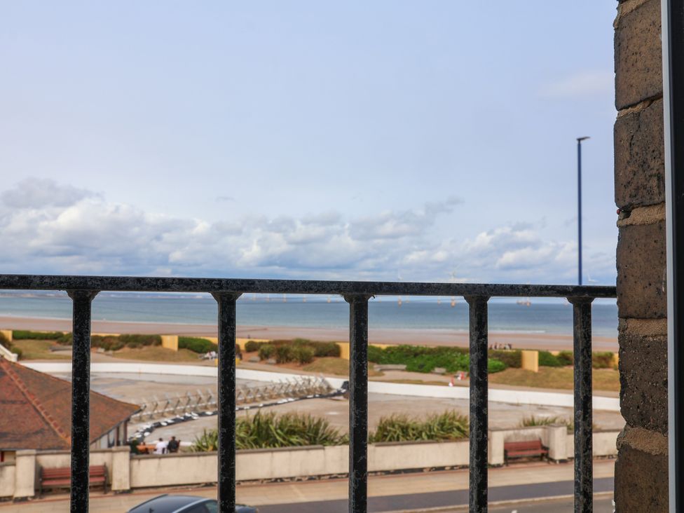 A view of the sea and beach from a railing at Apartment 3 (2 bed) in Redcar