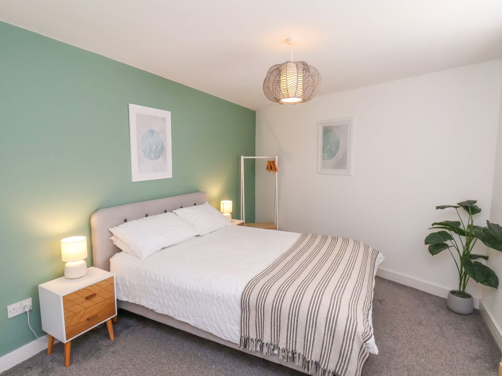 A bedroom with a bed and nightstand at Apartment 3 (2 bed) Redcar