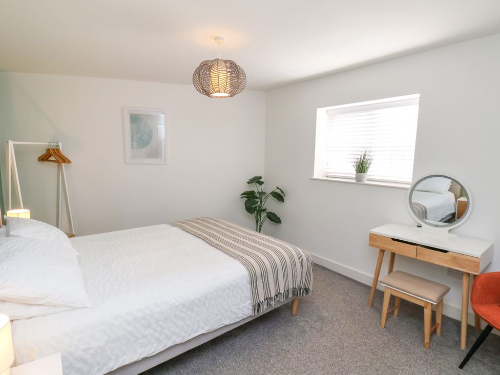 A bedroom with a bed and a dressing table at Apartment 3 (2 bed) in Redcar