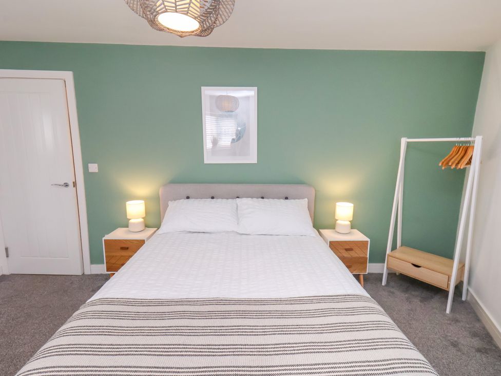 A bedroom with a bed and nightstands at Apartment 3 (2 bed) in Redcar