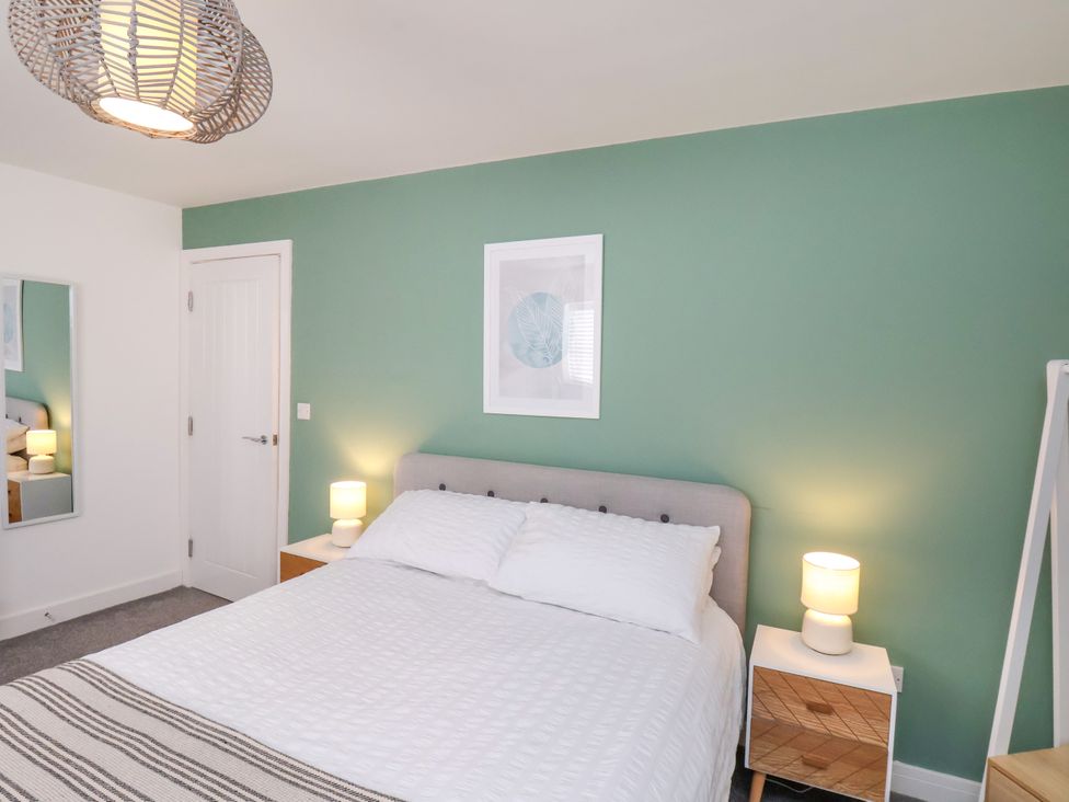 A bedroom with a bed and nightstand at Apartment 3 ( 2 bed ) in Redcar