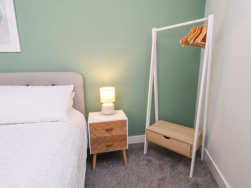 A bedroom with a bed and nightstand at Apartment 3 (2 bed) in Redcar