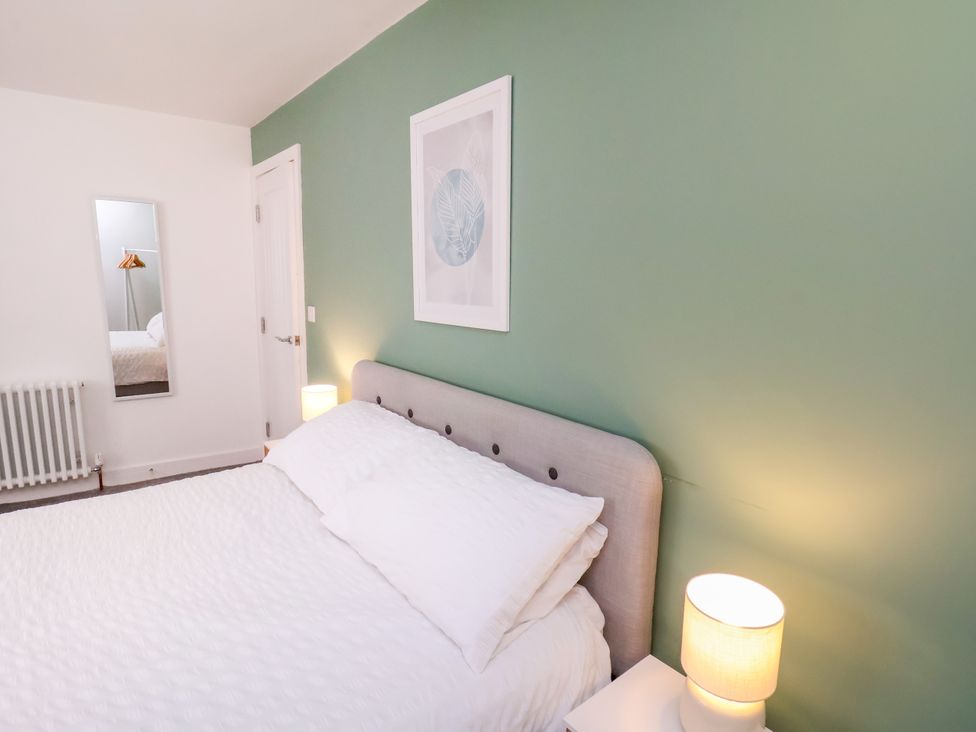 A bedroom with a bed and lamp at Apartment 3 (2 bed) in Redcar